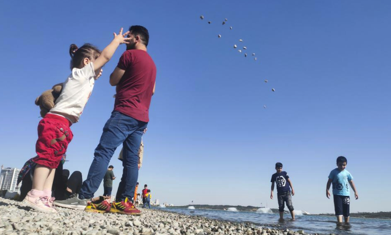 People have fun beside a lake at a park in Tehran, Iran, June 2, 2023. (Xinhua/Shadati)