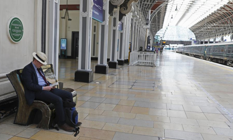 A man reads in Paddington Station in London, Britain, June 2, 2023. British rail workers are on strike due to a long-running dispute over pay and terms. (Xinhua/Li Ying)