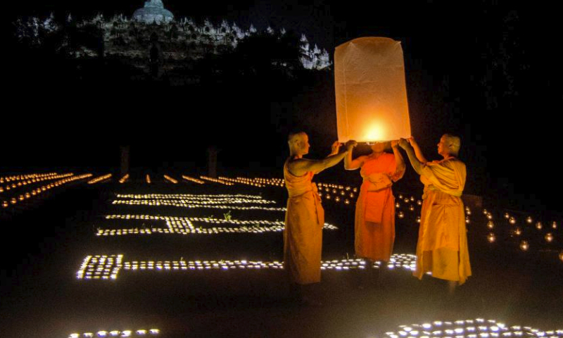 Buddhist monks release a flying lantern during the Vesak Day celebration at Borobudur temple in Magelang, Central Java, Indonesia, on June 4, 2023. (Photo by Agung Supriyantoo/Xinhua)