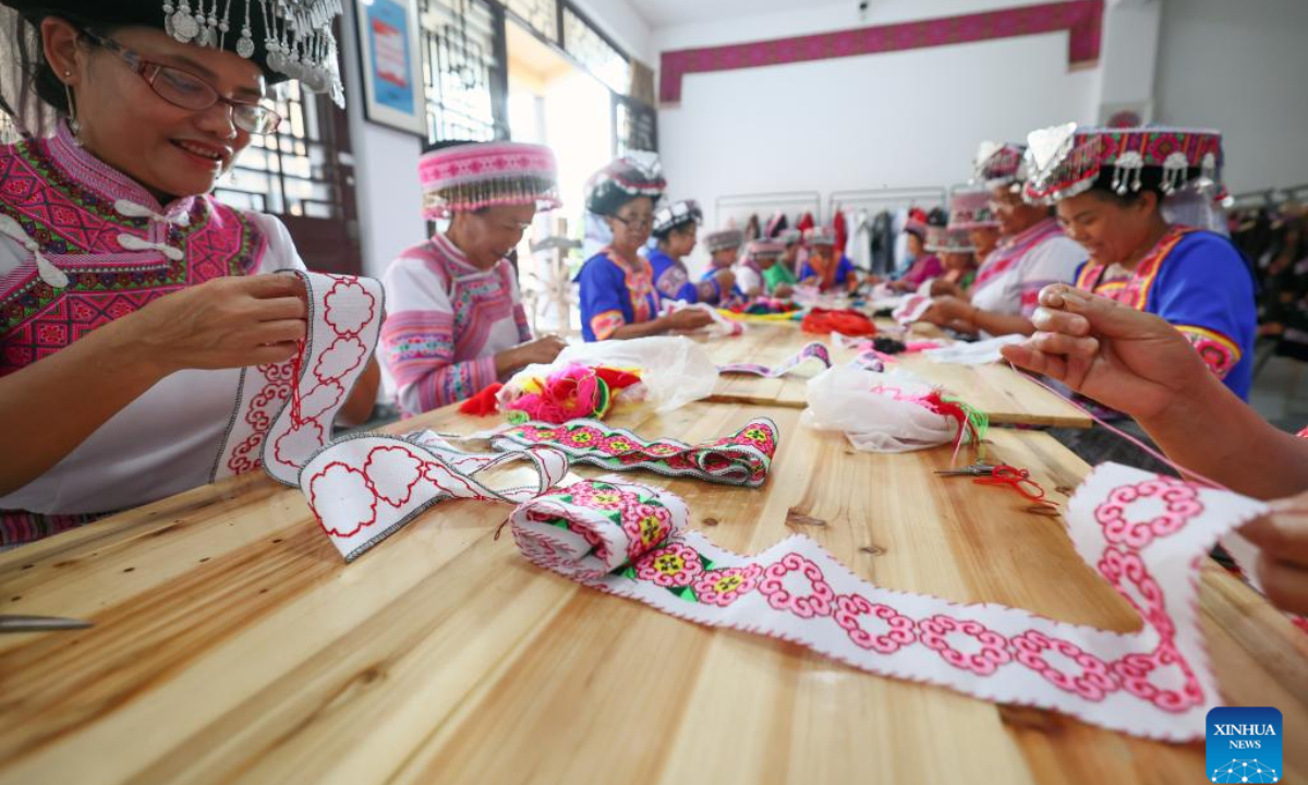 Women of Miao ethnic group make embroidery works at a workshop in Pingbian Miao Autonomous County, southwest China's Yunnan Province, June 1, 2023. Pingbian Miao Autonomous County has been making efforts to support and develop its embroidery industry, trying to provide job opportunities to local women. Photo:Xinhua