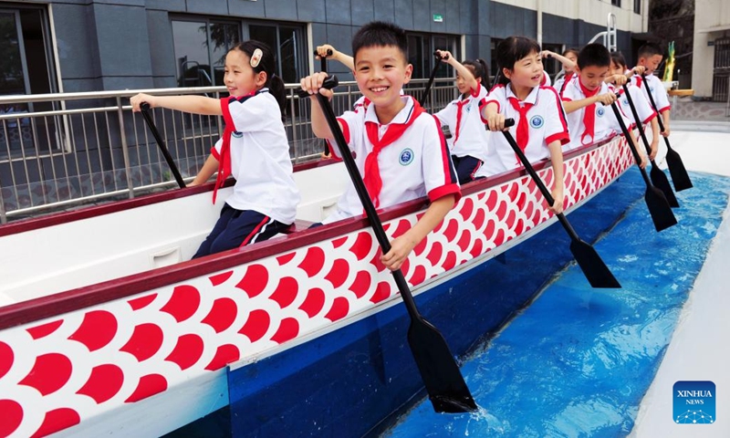 Children try rowing a dragon boat in a primary school in Yichang City, central China's Hubei Province, May 31, 2023. June 1 marks the International Children's Day. Various events were held nationwide with vibrant colors and joyful laughter as children and families gathered for celebration.(Photo: Xinhua)