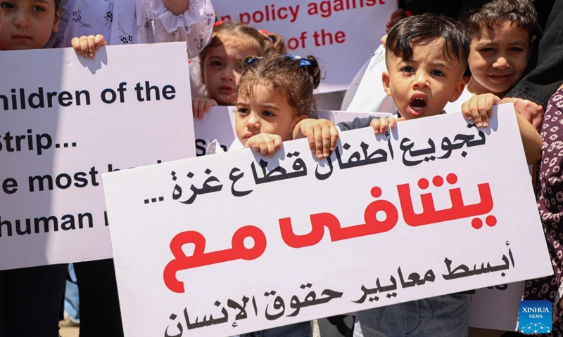 Palestinian children take part in a demonstration in Gaza City, on June 6, 2023. Palestinian children demonstrated on Tuesday in Gaza City to demand the UN World Food Programme (WFP) cancel its decision about stopping its humanitarian aid to poor families in the coastal enclave.(Photo: Xinhua)