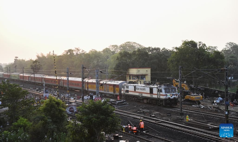 A passenger train passes by the site of a triple-train crash in Balasore district of the eastern Indian state of Odisha, June 5, 2023. Normal rail traffic has resumed both ways at the site where the triple-train crash had occurred on Friday in India's eastern state of Odisha, claiming 275 human lives, announced the federal Ministry of Railways on Monday.(Photo: Xinhua)