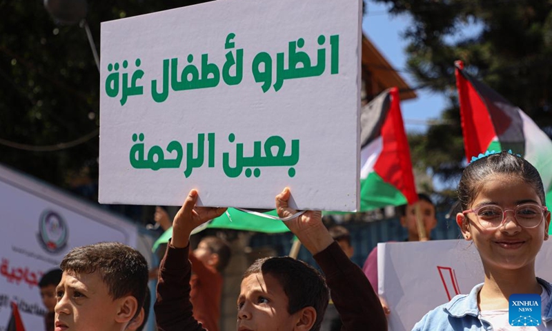 Palestinian children take part in a demonstration in Gaza City, on June 6, 2023. Palestinian children demonstrated on Tuesday in Gaza City to demand the UN World Food Programme (WFP) cancel its decision about stopping its humanitarian aid to poor families in the coastal enclave.(Photo: Xinhua)