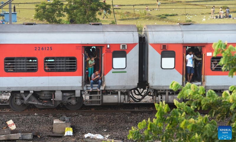 A passenger train passes by the site of a triple-train crash in Balasore district of the eastern Indian state of Odisha, June 5, 2023. Normal rail traffic has resumed both ways at the site where the triple-train crash had occurred on Friday in India's eastern state of Odisha, claiming 275 human lives, announced the federal Ministry of Railways on Monday.(Photo: Xinhua)