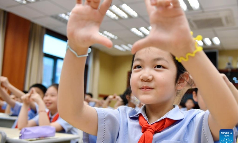 Students are guided to have their eyes checked via an interactive game at a primary school in Changxing County of Huzhou, east China's Zhejiang Province, June 5, 2023. Various activities themed on eye caring were held at schools across the country ahead of the National Eye Care Day, which falls on June 6.(Photo: Xinhua)