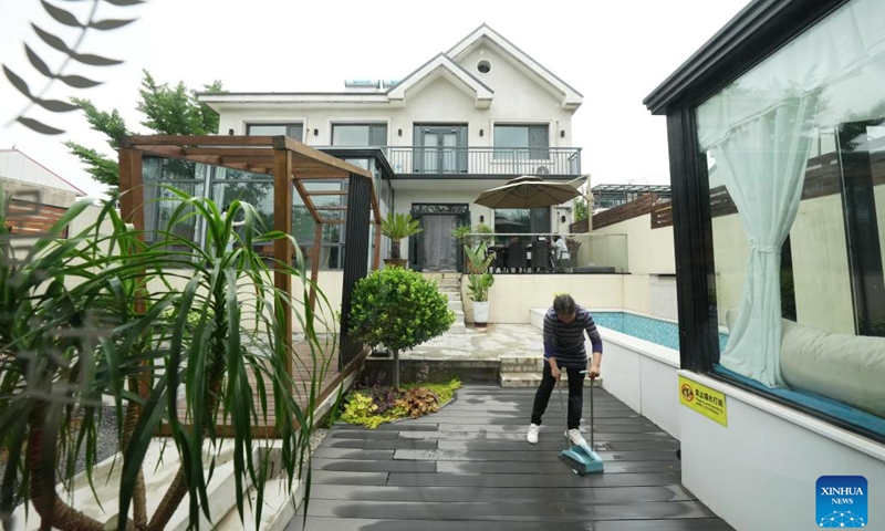 A staff member performs housekeeping at a high-end homestay in Feishizhuang Village, Qinhuangdao, north China's Hebei Province, June 5, 2023. Qinhuangdao, widely noted for its seaside tourist attractions, has pinned much importance to the development of homestay service in a way to accelerate the growth in its rural areas. To date, there are more than 2,200 homestays in operation in the region.(Photo: Xinhua)