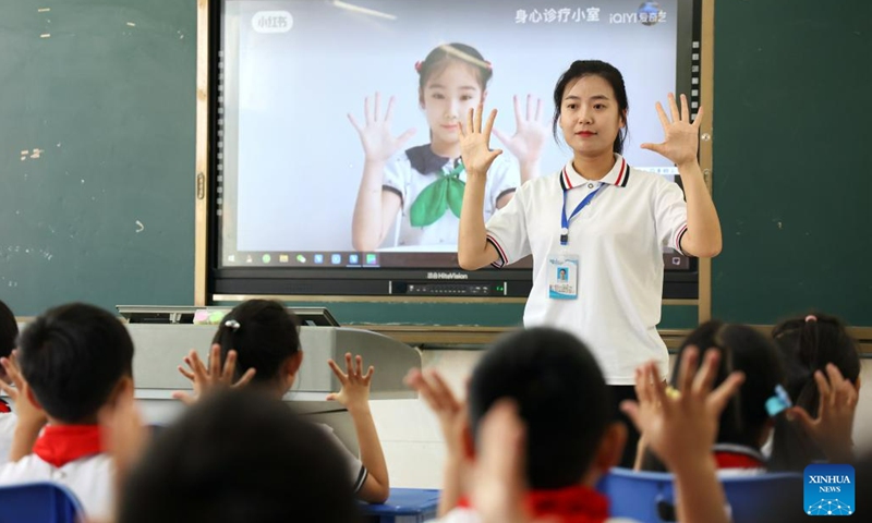 A teacher guides students to do eye exercises at a school in Binzhou, east China's Shandong Province, June 5, 2023. Various activities themed on eye caring were held at schools across the country ahead of the National Eye Care Day, which falls on June 6.(Photo: Xinhua)