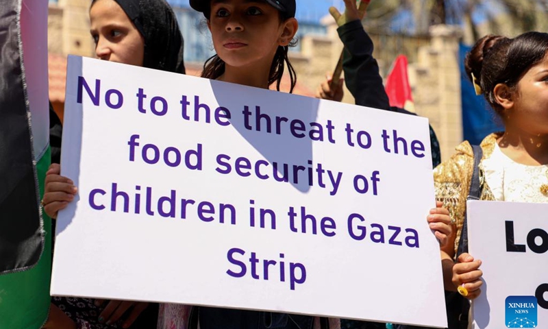 Palestinian children take part in a demonstration in Gaza City, on June 6, 2023. Palestinian children demonstrated on Tuesday in Gaza City to demand the UN World Food Programme (WFP) cancel its decision about stopping its humanitarian aid to poor families in the coastal enclave.(Photo: Xinhua)