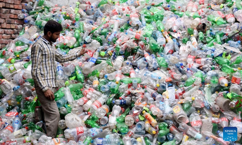 A worker checks recycled plastic bottles at a recycle workshop in Lahore, Pakistan on June 5, 2023. Pakistani Prime Minister Shahbaz Sharif has emphasized the urgent need to combat plastic pollution under the global theme solutions to plastic pollution, in marking World Environment Day.(Photo: Xinhua)