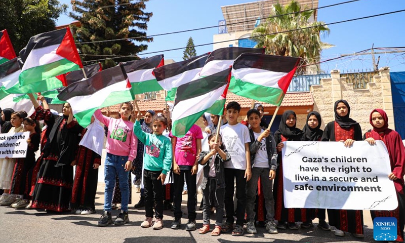 Palestinian children take part in a demonstration in Gaza City, on June 6, 2023. Palestinian children demonstrated on Tuesday in Gaza City to demand the UN World Food Programme (WFP) cancel its decision about stopping its humanitarian aid to poor families in the coastal enclave.(Photo: Xinhua)