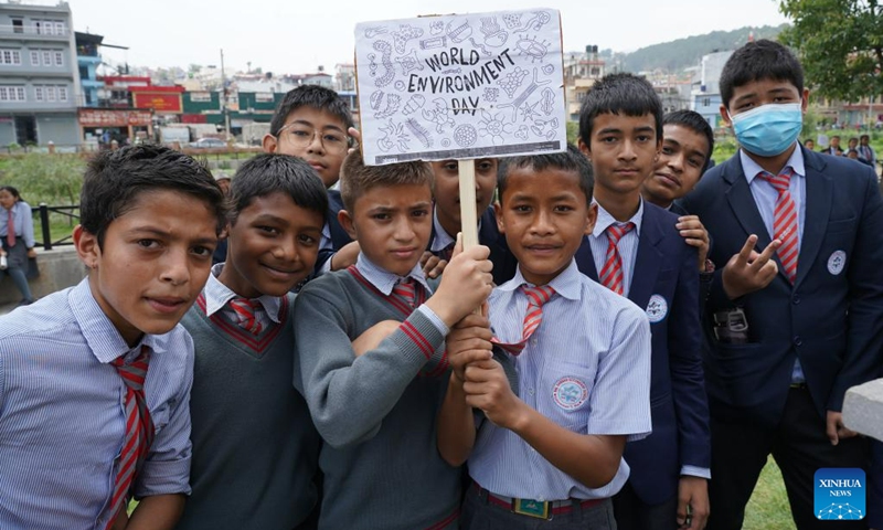 Students hold a placard aimed at raising awareness of environment protection on the occasion of World Environment Day in Kathmandu, Nepal, June 5, 2023(Photo: Xinhua)