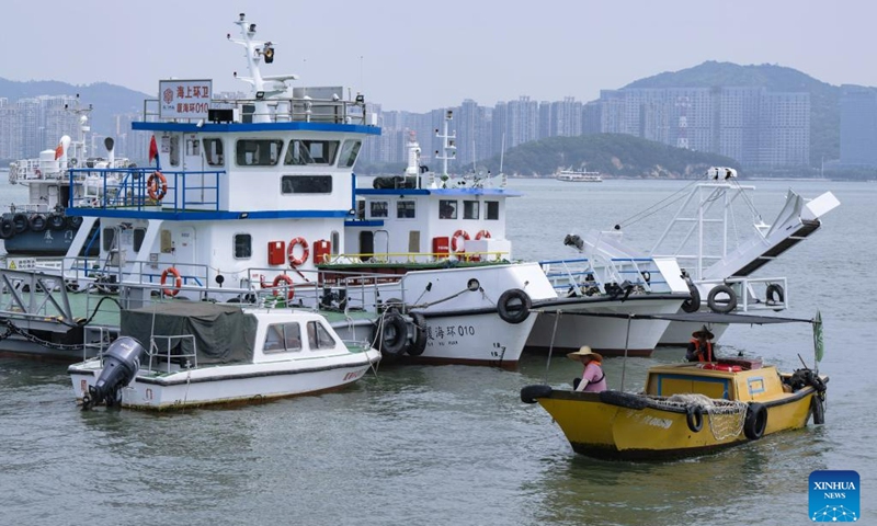 This photo shows a mechanical sanitation vessel and a sanitation boat at a dock in Xiamen, southeast China's Fujian Province, June 4, 2023. Founded in 1994, the ocean sanitation station in Xiamen has been dedicated to the removal of marine waste and is now equipped with four sanitation docks, six mechanical sanitation vessels, 48 sanitation boats and more than 160 staff members.(Photo: Xinhua)