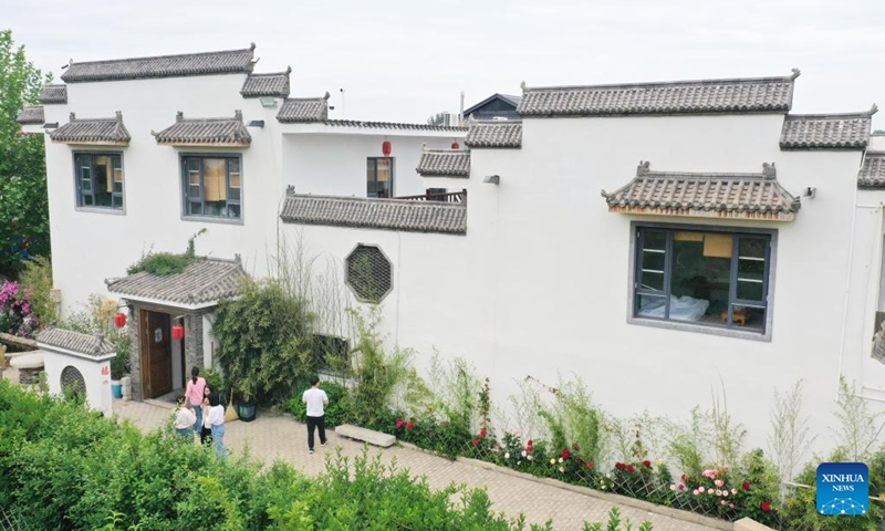 This aerial photo taken on June 5, 2023 shows guests chatting in the courtyard of a high-end homestay in Feishizhuang Village, Qinhuangdao, north China's Hebei Province. Qinhuangdao, widely noted for its seaside tourist attractions, has pinned much importance to the development of homestay service in a way to accelerate the growth in its rural areas. To date, there are more than 2,200 homestays in operation in the region.(Photo: Xinhua)