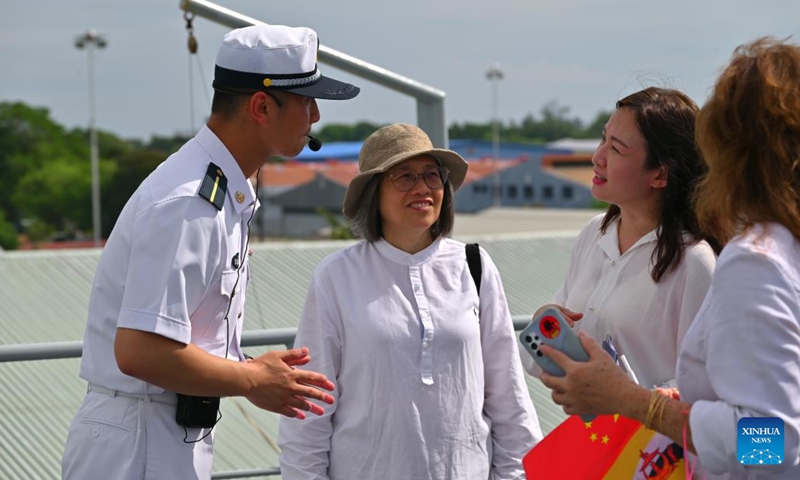 A Chinese navy member introduces Chinese naval training ship Qi Jiguang to visitors at Muara Port in Brunei, June 5, 2023.(Photo: Xinhua)