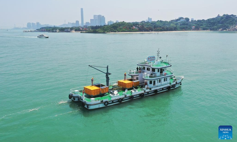 This aerial photo shows a sanitation vessel sailing in the waters of Xiamen, southeast China's Fujian Province, June 4, 2023. Founded in 1994, the ocean sanitation station in Xiamen has been dedicated to the removal of marine waste and is now equipped with four sanitation docks, six mechanical sanitation vessels, 48 sanitation boats and more than 160 staff members.(Photo: Xinhua)