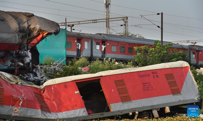 A passenger train passes by the site of a triple-train crash in Balasore district of the eastern Indian state of Odisha, June 5, 2023. Normal rail traffic has resumed both ways at the site where the triple-train crash had occurred on Friday in India's eastern state of Odisha, claiming 275 human lives, announced the federal Ministry of Railways on Monday.(Photo: Xinhua)