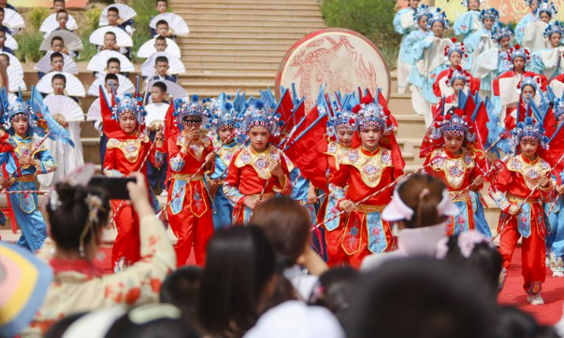 People watch an opera performance during the Qiuci culture and tourism festival in Kuqa City of Aksu Prefecture, northwest China's Xinjiang Uygur Autonomous Region, June 17, 2023. The Qiuci culture tourism festival kicked off here on Saturday. (Xinhua/Hao Zhao)