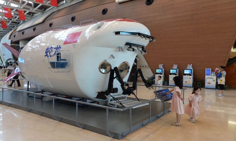 A child looks at a life-size model of China's manned submersible Jiaolong at the National Maritime Museum of China in North China's Tianjin Municipality on June 9, 2023. Jiaolong set a diving record of 7,062 meters in the Mariana Trench in June 2012, making China the fifth country to obtain the technology to make a submersible dive to more than 3,500 meters below sea level. Photo: VCG