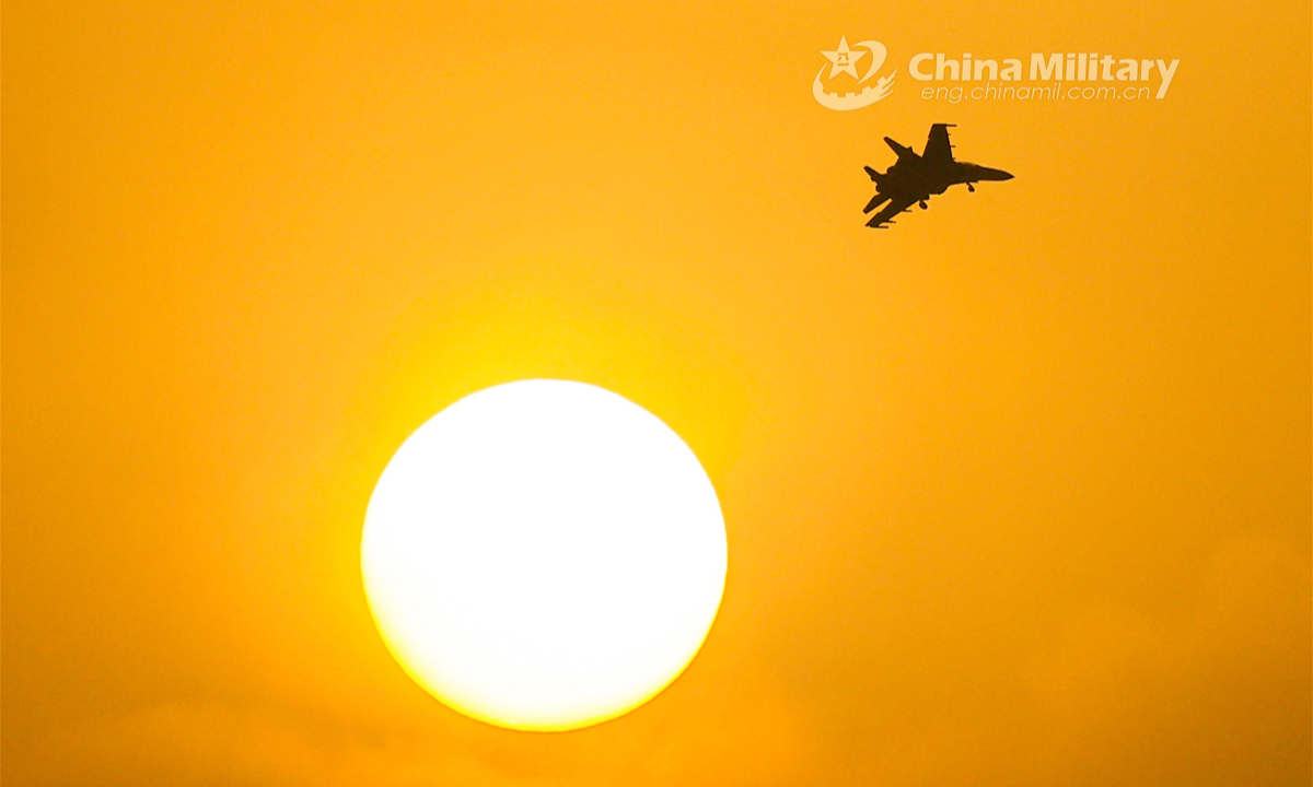 A fighter jet attached to a brigade under the PLA Air Force Xi'an Flying College bathes in sunset's fading light during a round-the-clock training mission in early June, 2023. Photo: China Military