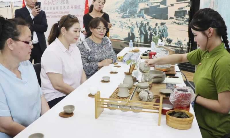 Visitors wait to taste tea at a Chinese tea culture exhibition in Sainshand, capital of the southeastern Mongolian province of Dornogovi, June 16, 2023. A Chinese tea culture exhibition opened on Friday here. Various types of tea and tea sets, as well as paintings and books on Chinese tea culture and the ancient Great Tea Road that connects Asia and Europe, are being showcased at the event. (Photo by Suriya/Xinhua)