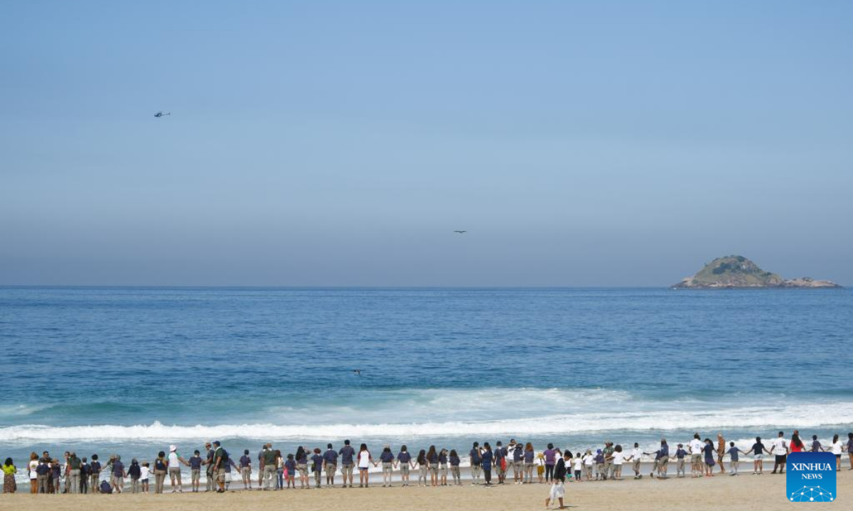 Volunteers take part in an activity to symbolically embrace the ocean at Sao Conrado Beach in Rio de Janeiro, Brazil, on June 8, 2023, the World Oceans Day. Photo:Xinhua