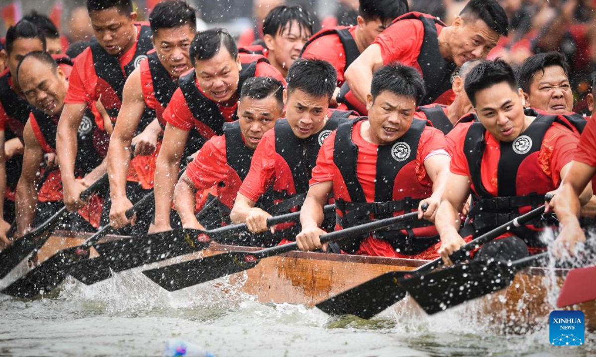 People take part in a dragon boat racing in Guangzhou, south China's Guangdong Province, June 15, 2023. Photo:Xinhua