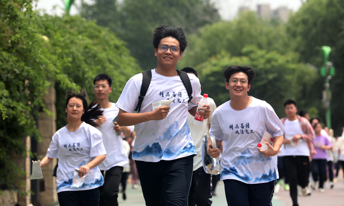 Students run out of the exam center after the first exam of <em>gaokao</em> in Anyang, Central China's Henan Province on June 7, 2023. 