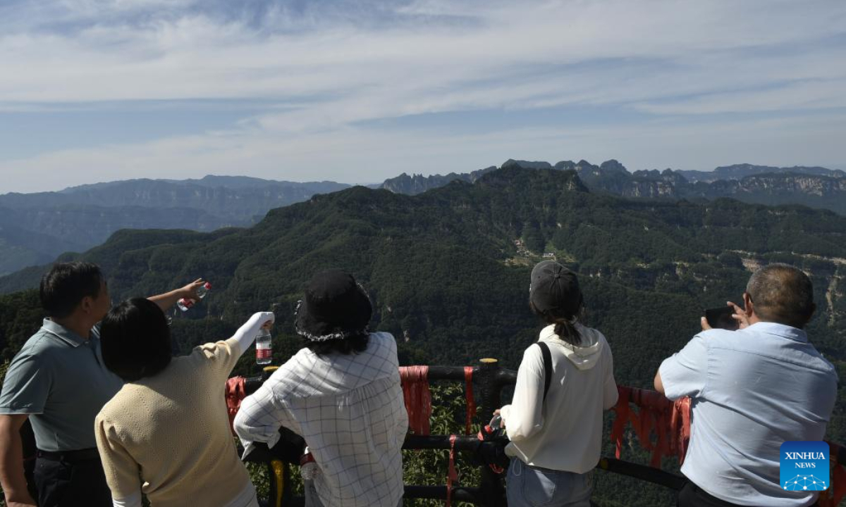 People visit the Wangwu Mountain scenic spot in Jiyuan City, central China's Henan Province, June 15, 2023. Wangwu Mountain is located in Jiyuan City, Henan Province, where the ancient Chinese fable 