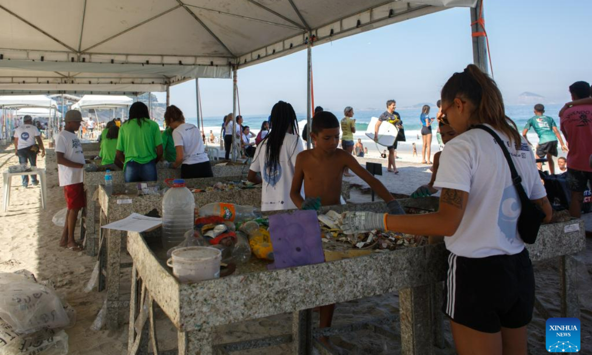 Volunteers sort the collected waste at Sao Conrado Beach in Rio de Janeiro, Brazil, on June 8, 2023, the World Oceans Day. Photo:Xinhua