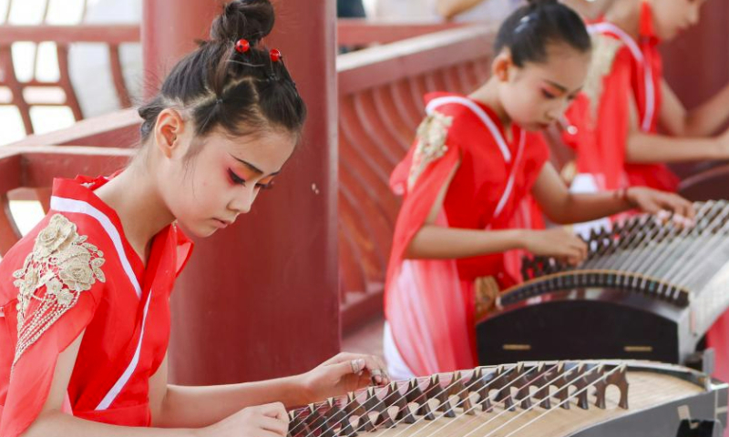 Children play guzheng, a traditional Chinese musical instrument, during the Qiuci culture and tourism festival in Kuqa City of Aksu Prefecture, northwest China's Xinjiang Uygur Autonomous Region, June 17, 2023. The Qiuci culture tourism festival kicked off here on Saturday. (Xinhua/Hao Zhao)