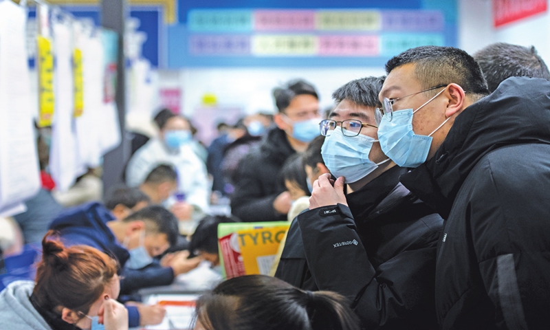 Two college graduates read a job description at a recruitment fair held in Taiyuan, North China's Shanxi Province. Photo:cnsphoto