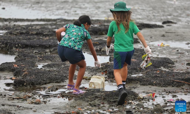 Students collect trash at a beach in Suva, Fiji, June 7, 2023. Students and staff members from a school in Suva took part in a beach cleanup activity on Wednesday to mark the annual World Oceans Day which falls on June 8.(Photo: Xinhua)