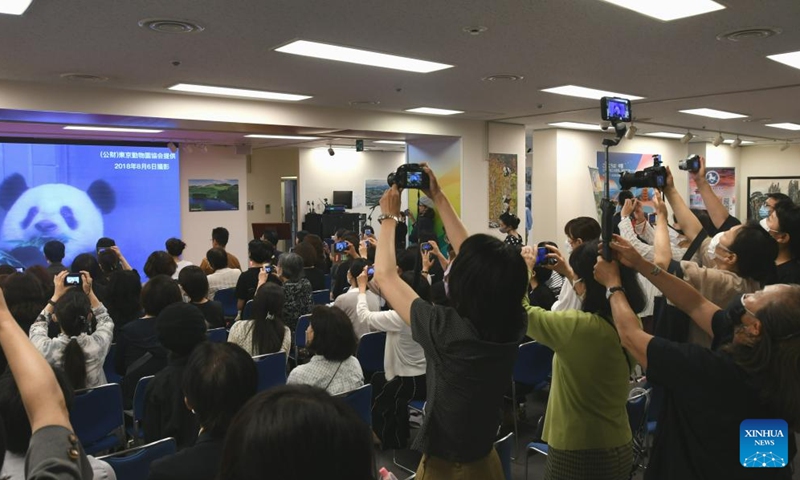 People watch a video of giant panda Xiang Xiang in Tokyo, Japan, June 12, 2023. Xiang Xiang was born in June 2017 at Ueno Zoo, where she gained much popularity. Her parents Shin Shin (female) and Ri Ri (male) were both on loan from China, where the ownership of the cubs they give birth to belongs. It was the first time a panda cub was born at Ueno Zoo in nearly 29 years.(Photo: Xinhua)