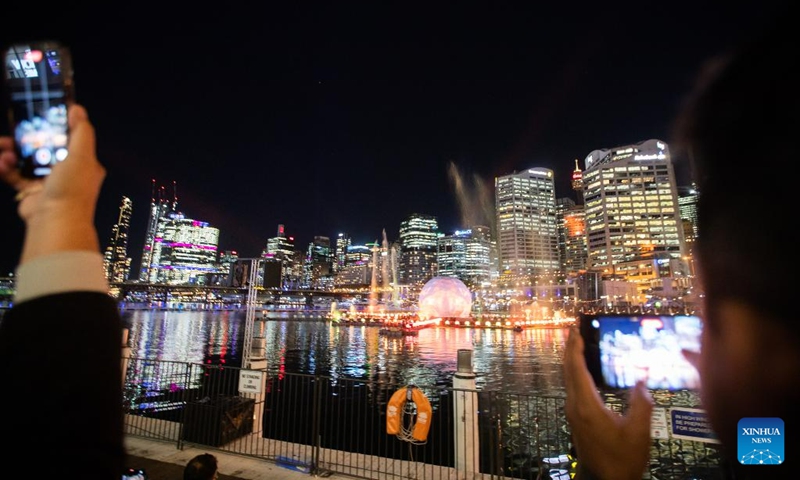 People take pictures of a light show during the Vivid Sydney light festival in Sydney, Australia, June 7, 2023. As one of Sydney's most iconic events, Vivid Sydney is held from May 26 to June 17 this year, celebrating the soul of Sydney with illuminations, installations and interactive events.(Photo: Xinhua)