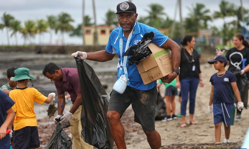 Students and teachers collect trash at a beach in Suva, Fiji, June 7, 2023. Students and staff members from a school in Suva took part in a beach cleanup activity on Wednesday to mark the annual World Oceans Day which falls on June 8.(Photo: Xinhua)