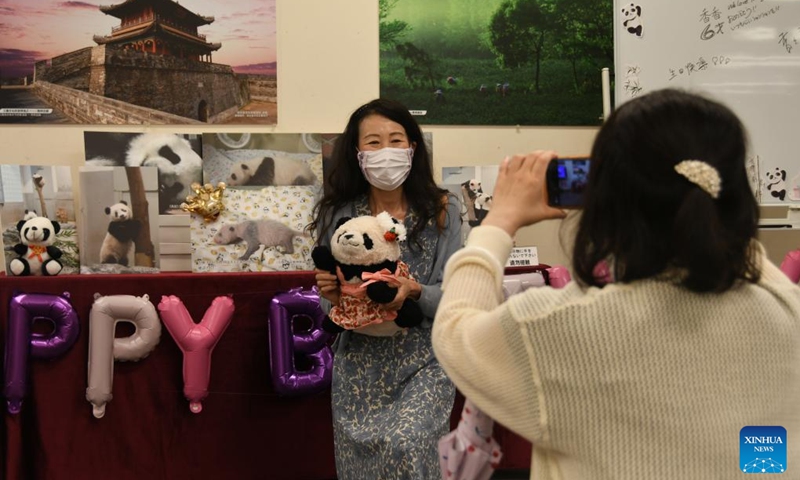 A woman poses for photos at a birthday party of giant panda Xiang Xiang in Tokyo, Japan, June 12, 2023. Xiang Xiang was born in June 2017 at Ueno Zoo, where she gained much popularity. Her parents Shin Shin (female) and Ri Ri (male) were both on loan from China, where the ownership of the cubs they give birth to belongs. It was the first time a panda cub was born at Ueno Zoo in nearly 29 years.(Photo: Xinhua)