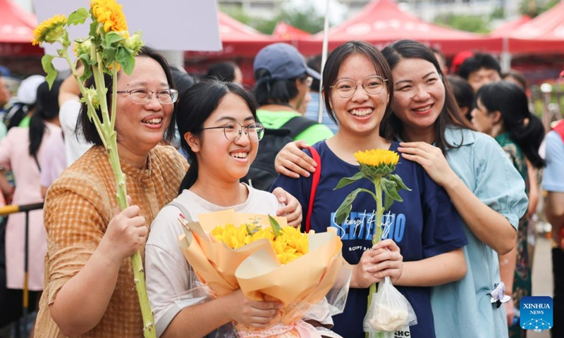 Examinees and their relatives pose for photos at an exam site in Nanning, south China's Guangxi Zhuang Autonomous Region, June 8, 2023. China's annual college entrance exam concluded on Thursday in some parts of the country. The exam, also known as the gaokao, saw a record 12.91 million candidates sign up this year.(Photo: Xinhua)