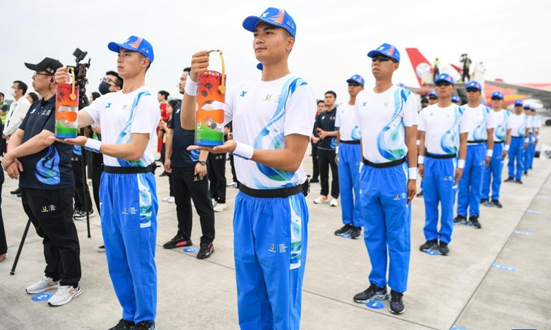 Staff members hold the World University Games flame at the Chengdu Tianfu International Airport in Chengdu, southwest China's Sichuan Province, on June 8, 2023. The launch ceremony of the torch relay for the 31st FISU Summer World University Games was held at the Chengdu Tianfu International Airport on Thursday.(Photo: Xinhua)