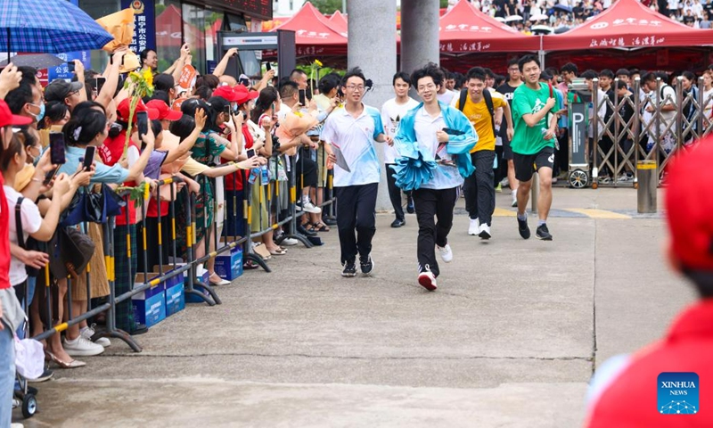 Examinees run out of an exam site in Nanning, south China's Guangxi Zhuang Autonomous Region, June 8, 2023. China's annual college entrance exam concluded on Thursday in some parts of the country. The exam, also known as the gaokao, saw a record 12.91 million candidates sign up this year.(Photo: Xinhua)