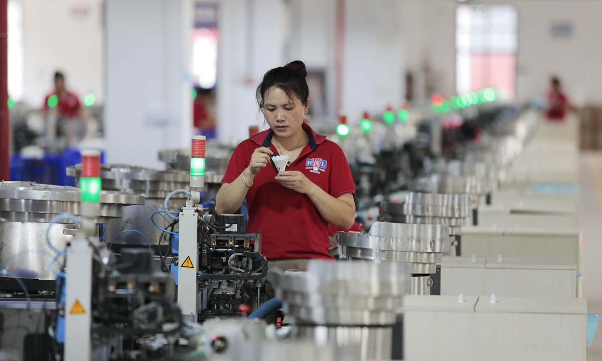 An employee checks a shuttlecock at a factory in Qiandongnan Miao and Dong Autonomous Prefecture, Southwest China's Guizhou Province on June 15, 2023. With the approach of the 19th Asian Games, which will take place in Hangzhou, East China's Zhejiang Province from September 29 to October 8, the factory is seeing surging demand for badminton equipment. Photo: VCG