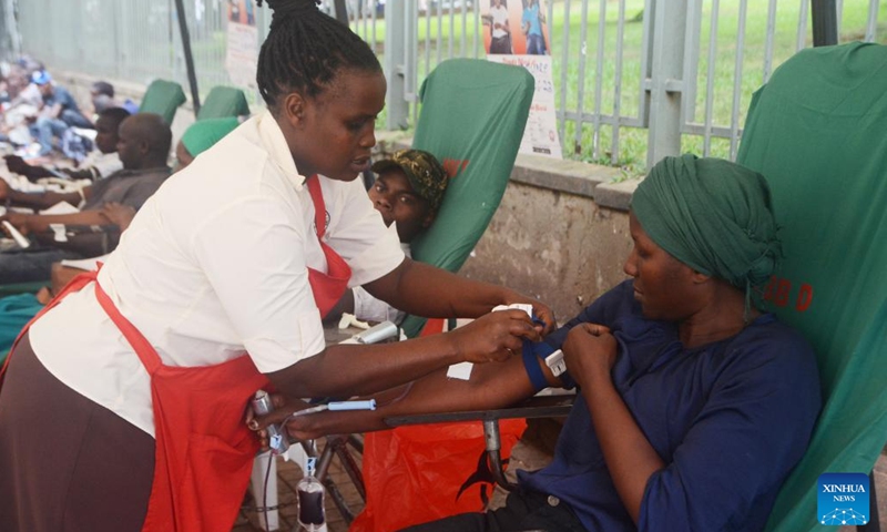 A health officer takes blood from a volunteer on the occasion of World Blood Donor Day in Kampala, Uganda, on June 14, 2023.(Photo: Xinhua)