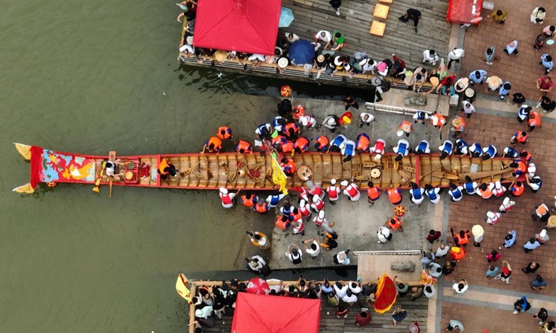 This aerial photo shows a dragon boat being pushed into water during a cultural event to celebrate the upcoming Dragon Boat Festival in Putian, southeast China's Fujian Province, June 13, 2023. A series of cultural events is going to be held in Putian to celebrate the traditional Dragon Boat Festival, which falls on June 22 this year.(Photo: Xinhua)