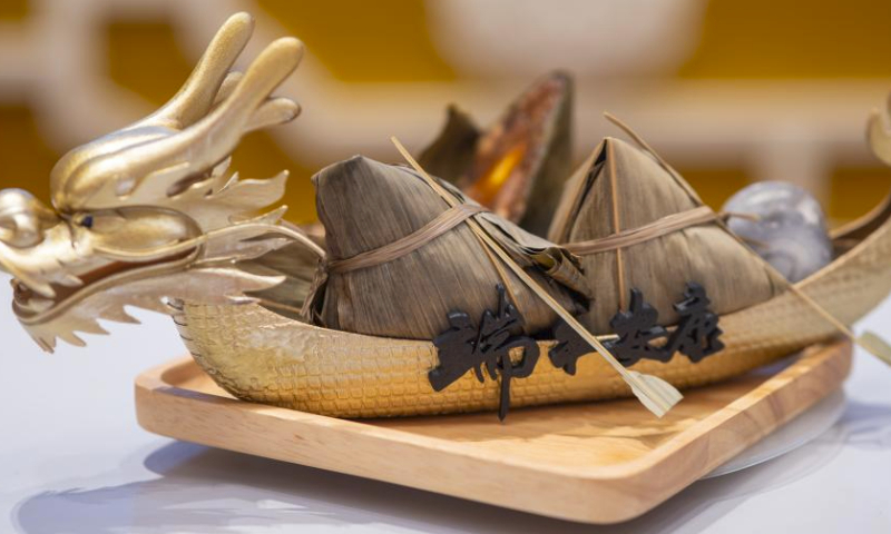 Zongzi, a pyramid-shaped glutinous rice dumpling wrapped in bamboo or reed leaves, is demonstrated during a Zongzi wrapping contest in celebration of the upcoming Chinese Dragon Boat Festival in Kuala Lumpur, Malaysia, June 18, 2023. (Photo by Chong Voon Chung/Xinhua)