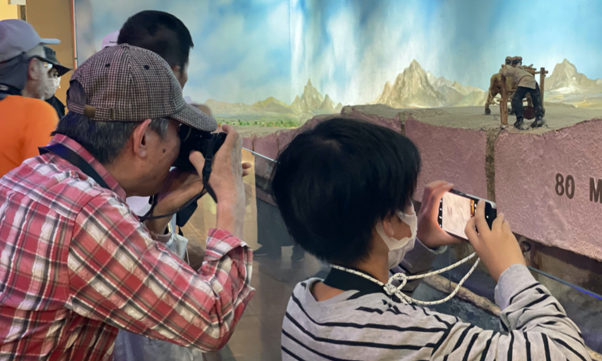 Japanese tourists learn how a qanat, a system for transporting water from aquifer or water well to the surface through an underground aqueduct that originated around 3,000 years ago in Turpan of Xinjiang region on June 21, 2023. Photo: Liu Xin/GT