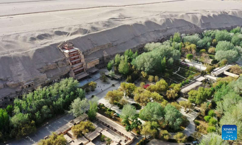 This aerial photo taken on April 25, 2023 shows the Mogao Grottoes in Dunhuang, northwest China's Gansu Province. As a key pass along the ancient Silk Road, Dunhuang is home to the Mogao Grottoes, a UNESCO World Heritage Site that boasts a vast collection of Buddhist artworks -- more than 2,000 colored sculptures and 45,000 square meters of murals are located in 735 caves. (Xinhua/Chen Bin)