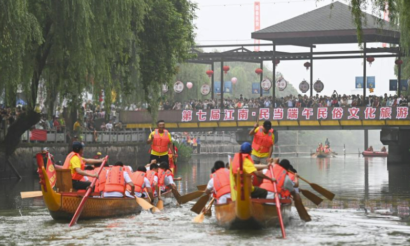 Villagers participate in a dragon boat race to mark the upcoming traditional Chinese Dragon Boat Festival, in Mindang Village of Hefu Town, Huzhou City, east China's Zhejiang Province, June 18, 2023. Dragon Boat Festival, also known as Duanwu Festival, is a traditional holiday in China. It is celebrated on the fifth day of the fifth month of the Chinese lunar calendar. (Xinhua/Huang Zongzhi)