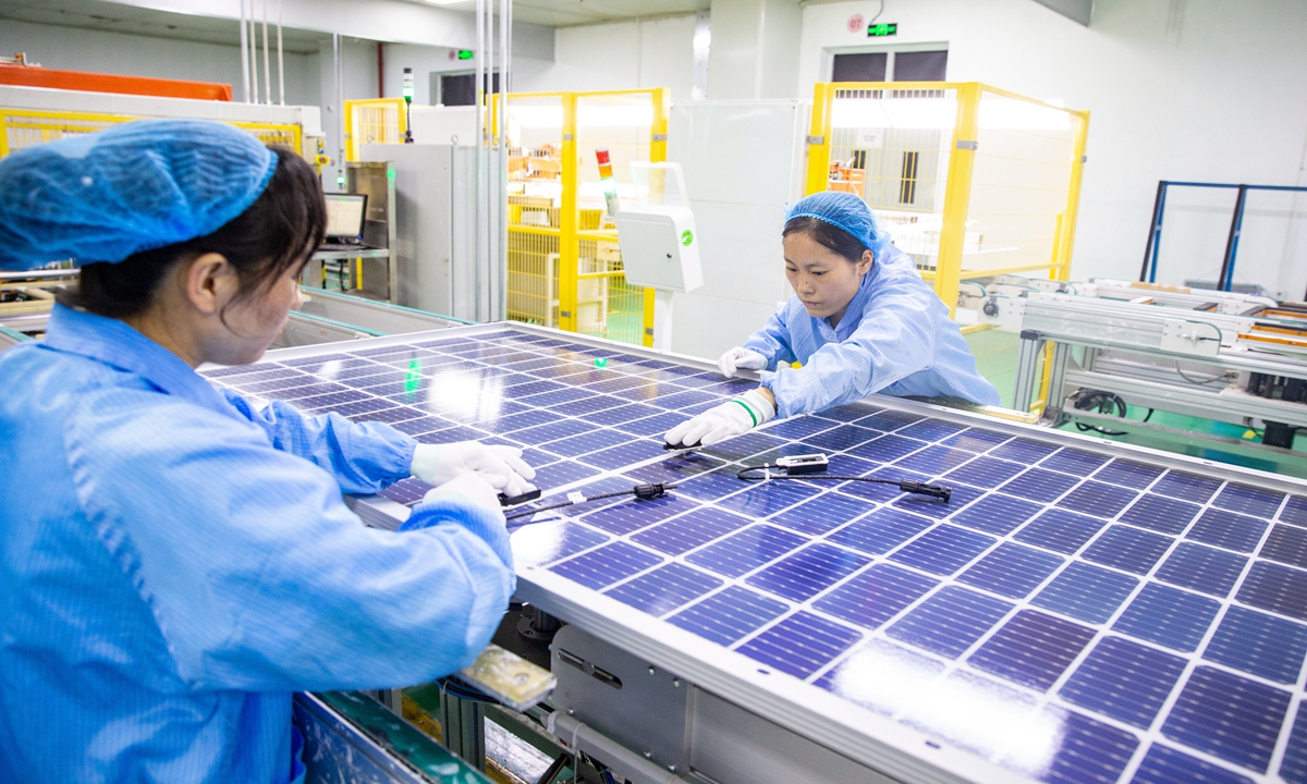 Workers make solar photovoltaic modules at a factory in Hai'an, East China's Jiangsu Province on June 19, 2023. Hai'an has been ramping up efforts to upgrade the local industrial chain, aiming to further elevate the competitiveness of the PV industry. China's total export of PV products exceeded $51.2 billion in 2022, up 80.3 percent year-on-year, industry data showed. Photo: cnsphoto