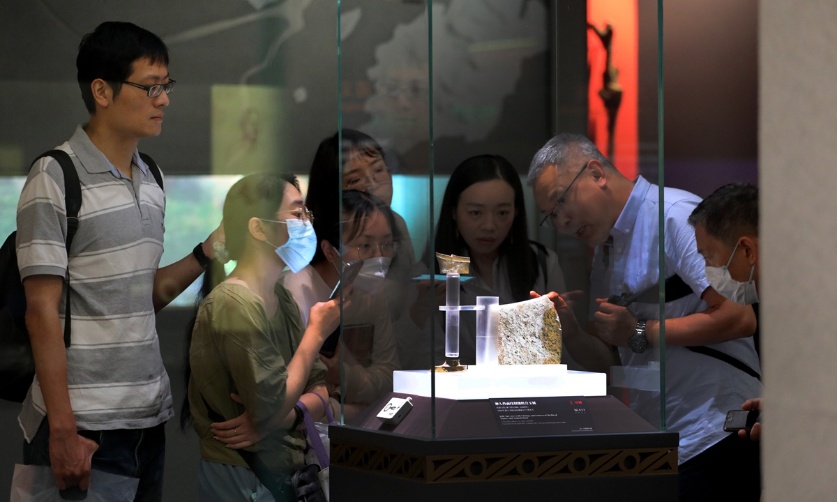 Visitors look at a precious relic, a 5,000-year-old jade yue (axe), at the Shanghai Museum on June 18, 2023. Photo: Chen Xia/Global Times