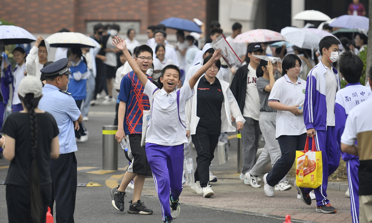 Students happily run out of a middle school in North China's Tianjin Municipality after finishing high school entrance exams on June 19, 2023. Photo: IC